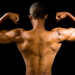 topless man with black background